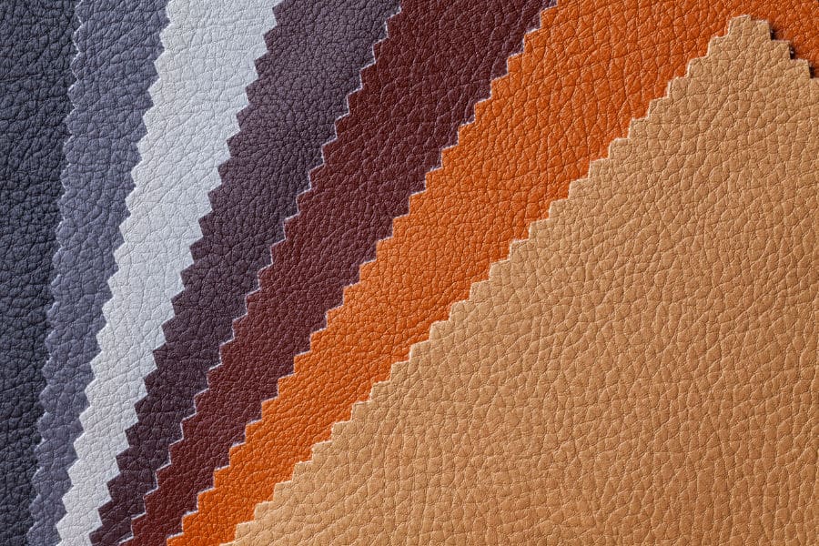 Sample of leather textile brown and gray colors, background. Catalog and palette tone of Interior fabric for furniture, closeup. Collection of multicolored cloth with skin pattern, macro.